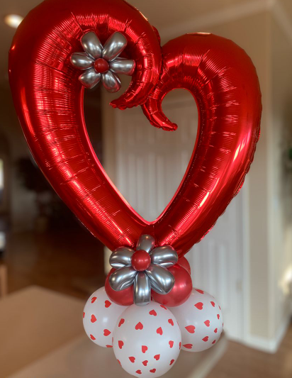 A vibrant and colorful arrangement of heart-shaped and love-themed balloons, perfect for expressing love and appreciation on Valentine's Day